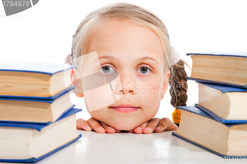 Image of  girl  between the books on isolated white