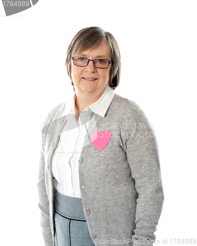 Image of Woman with pink paper heart on her jacket