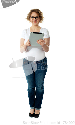Image of Full length of pretty woman holding tablet pc