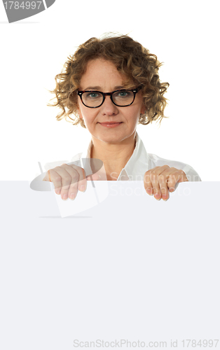Image of Aged woman behind big blank white banner ad