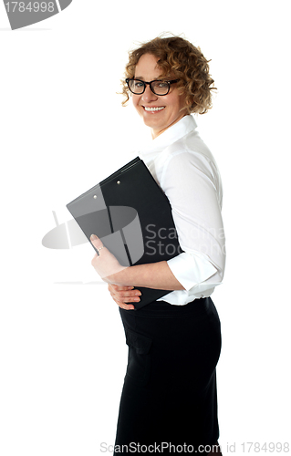 Image of Smiling corporate woman posing with clipboard