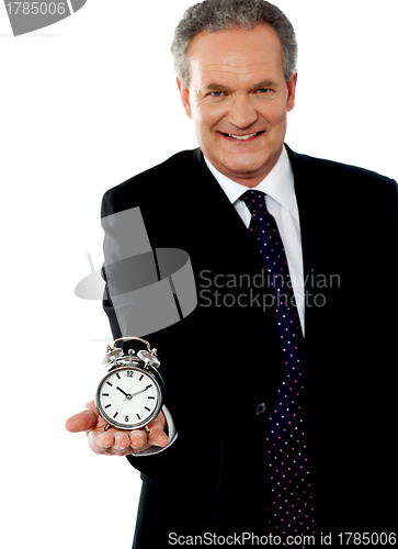 Image of Corporate man showing alarm clock