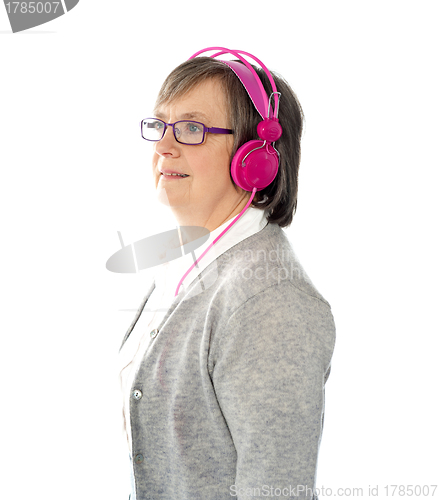 Image of Aged female listening to music