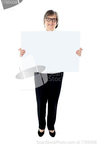 Image of Senior female executive showing advertising board