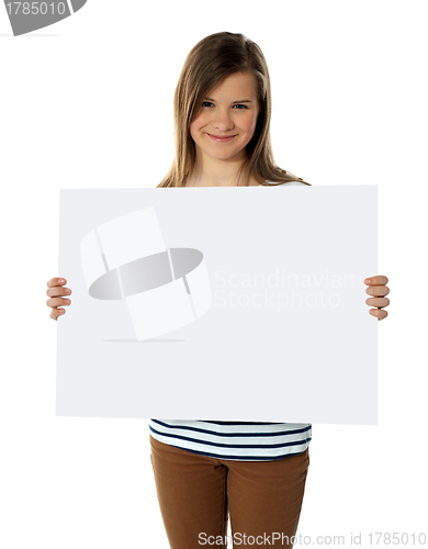 Image of Smiling teenager showing blank white billboard