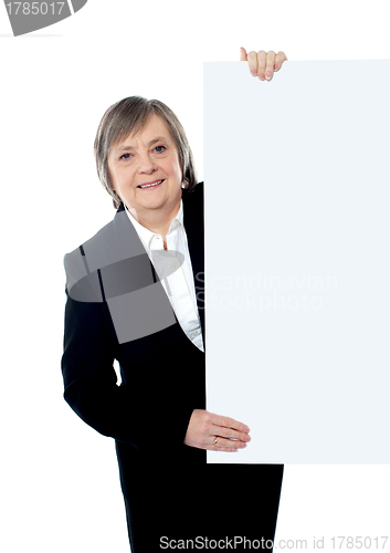 Image of Female executive holding blank whiteboard