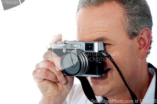 Image of Closeup view of a male photographer taking photo