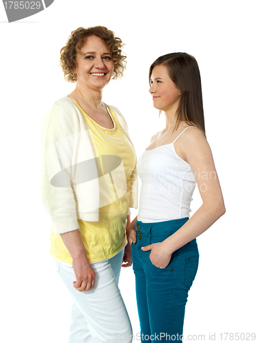 Image of Pretty teenage girl looking at her modern mum