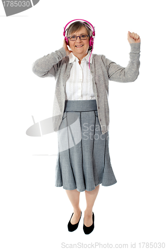 Image of Old woman enjoying music