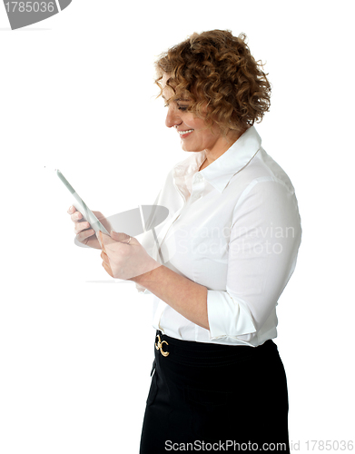 Image of Smiling businesswoman looking at tablet pc