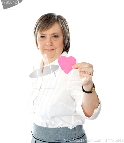 Image of Woman showing heart shaped pink paper