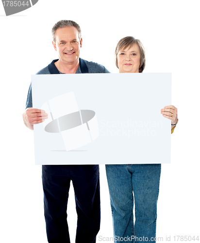 Image of Husband and wife displaying advertising board