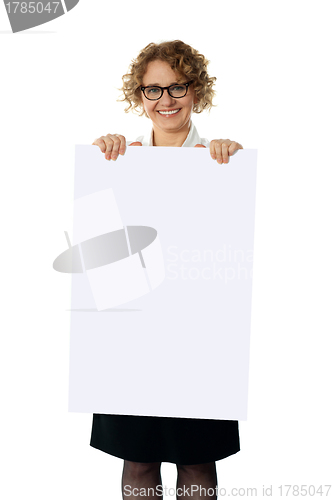 Image of Curly haired woman holding advertising board