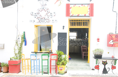 Image of coffee shop bar with colorful vintage Greece style chairs, stool