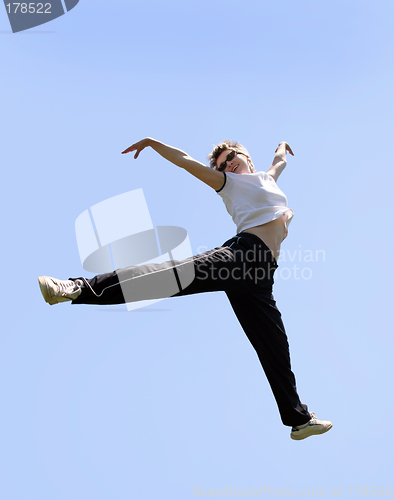 Image of Happy woman jumping high