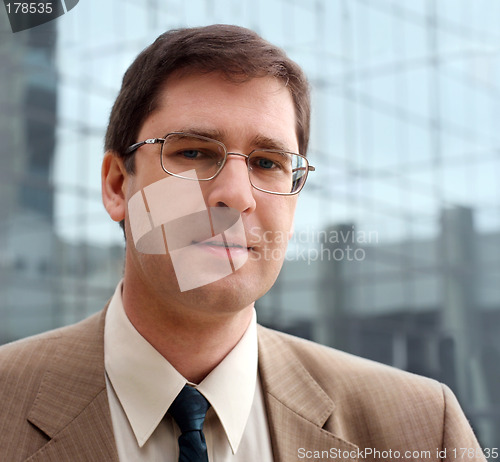 Image of Young businessman in front of the office building