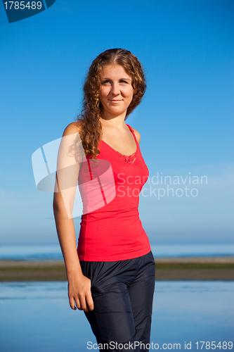 Image of girl doing morning exercises at the beach