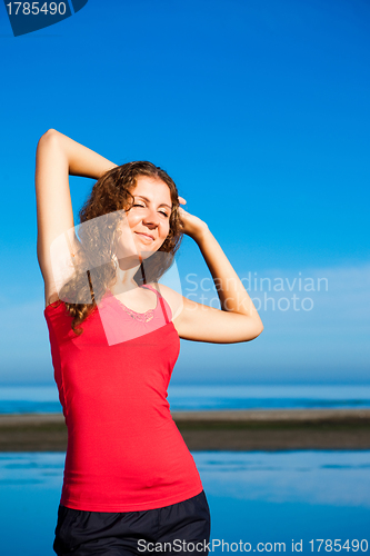Image of girl doing morning exercises at the beach