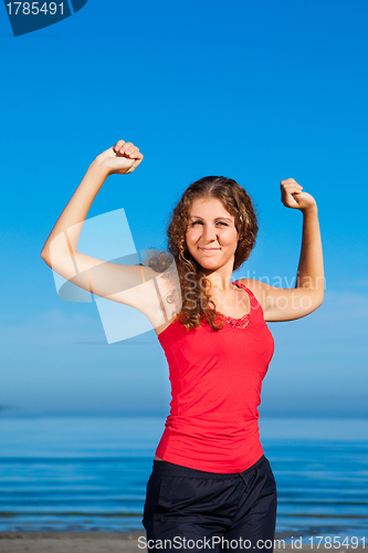 Image of girl doing morning exercises at the beach