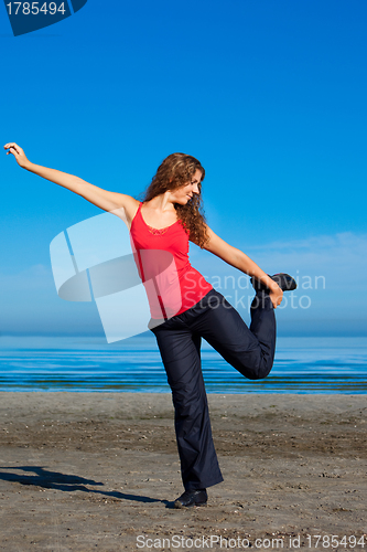 Image of girl doing morning exercises at the beach