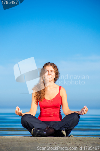 Image of girl doing morning exercises at the beach