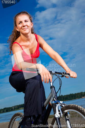 Image of beautiful woman with bicycle at the sea