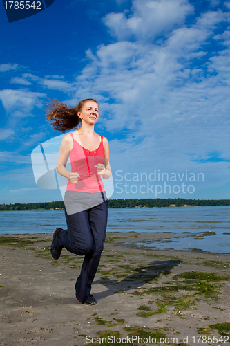 Image of Beautiful girl running at the beach