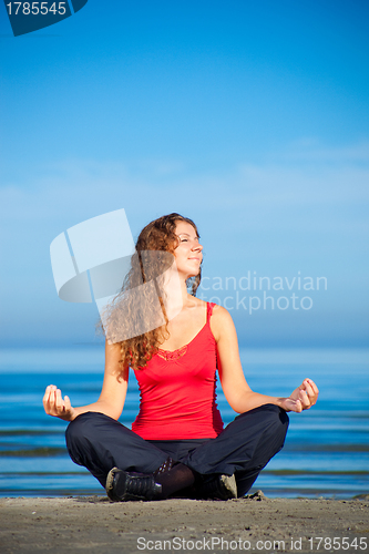 Image of girl doing morning exercises at the beach