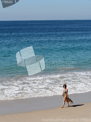 Image of Woman walking on the beach