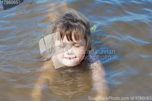 Image of Baby girl swimming in the river