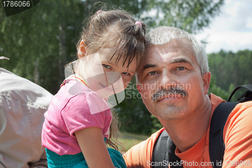 Image of Grandfather and granddaughter out for a walk