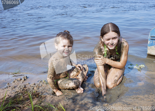 Image of Children in the mud on the river