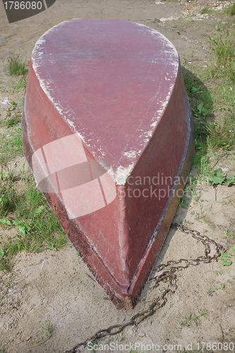 Image of The old boat overturned on the shore