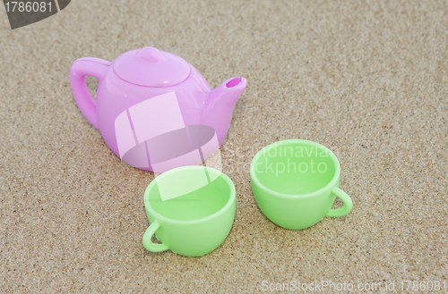 Image of Toy cups on the sand