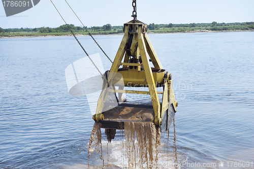 Image of Floating crane scoops soil