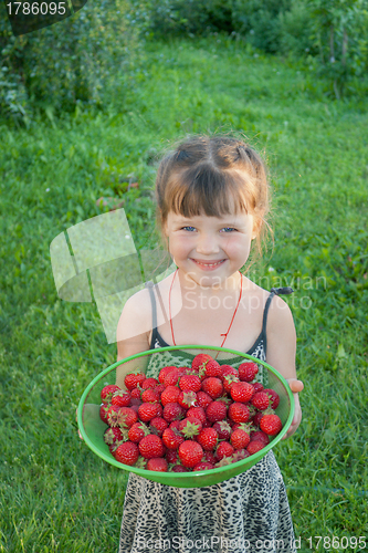 Image of The little girl with strawberries