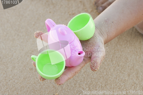 Image of Toy cups in baby hand