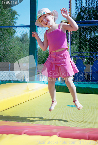 Image of The little girl  on a trampoline in park