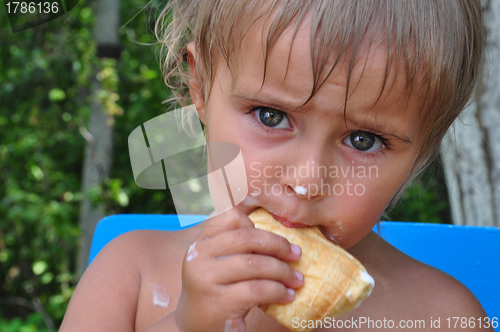 Image of child eating melting ice-cream