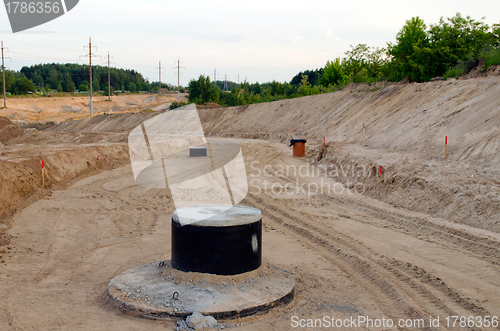 Image of Road construction.  Gravel  sewage wells 