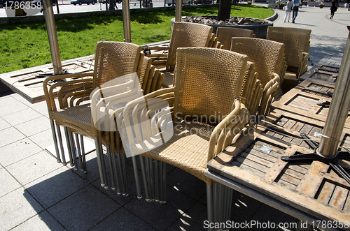 Image of Wicker chairs and tables on sidewalk 