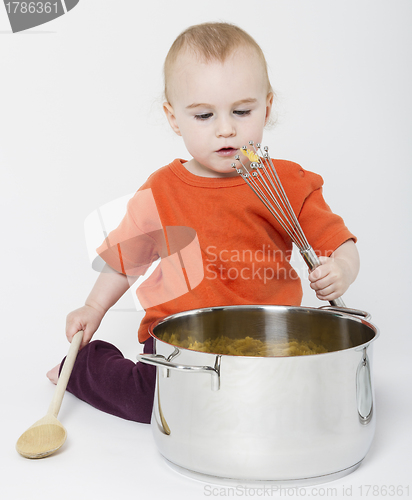 Image of baby with big cooking pot