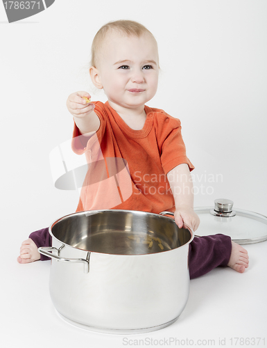Image of baby with big cooking pot