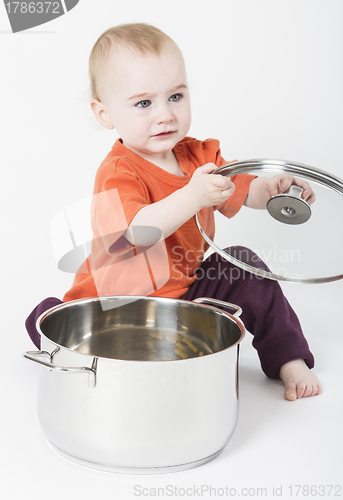 Image of baby with big cooking pot