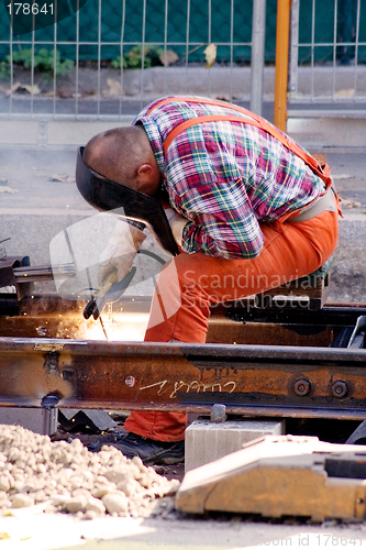 Image of Construction Worker Fixing Rails