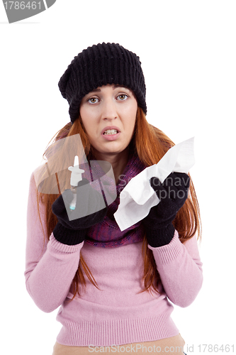 Image of woman with tissue and spray feels unwell with flu