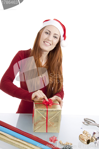 Image of young woman is packing  present for christmas isolated