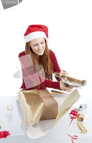 Image of young woman is packing  present for christmas isolated