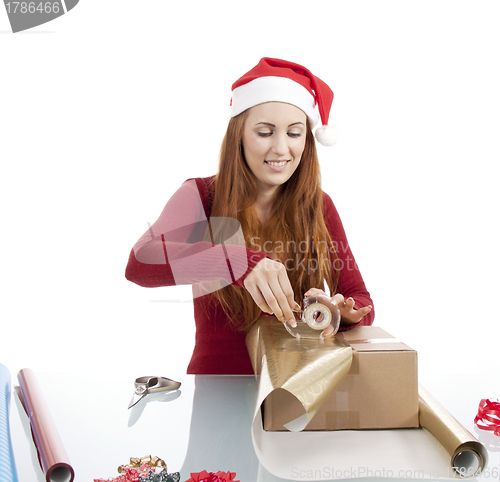 Image of young woman is packing  present for christmas isolated