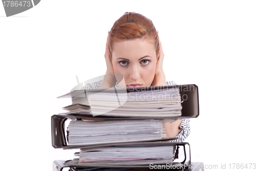 Image of business woman in office looks at unbelievable folder stack